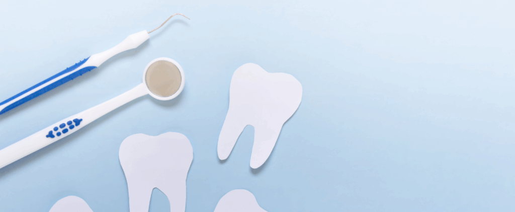 Various dental tools arranged on a sky-blue background.